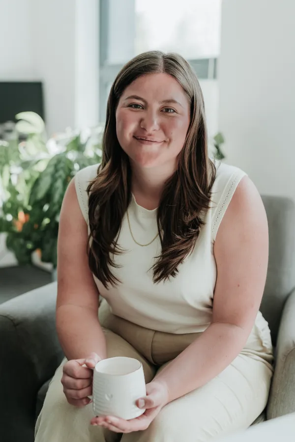 Woman holding a cup, relaxed setting.