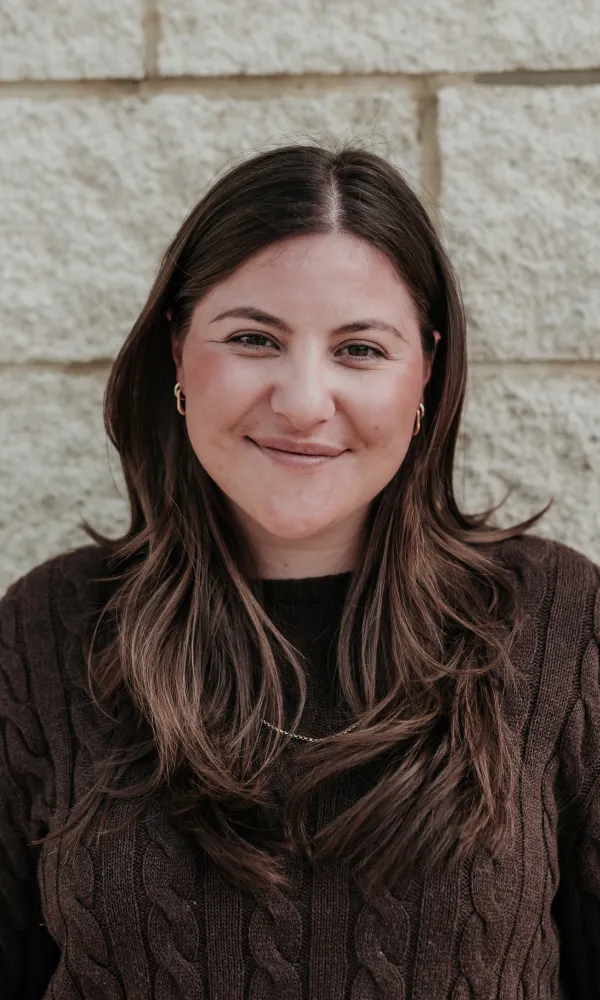 Woman with long, wavy brown hair.